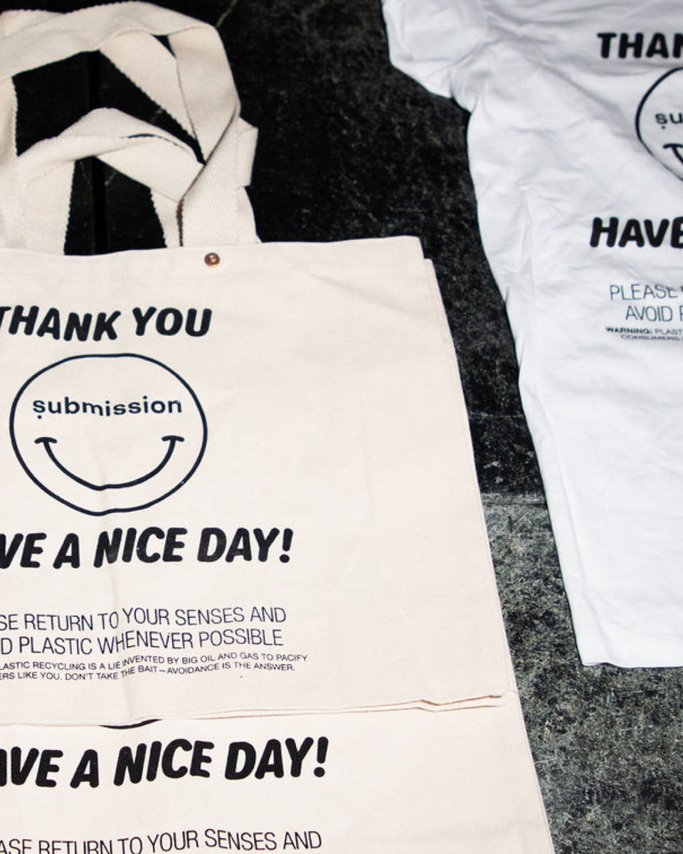 Submission Beauty Tote bag with text and smiley face design on a textured surface