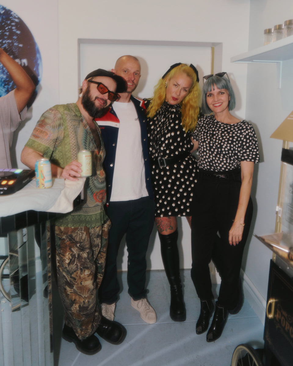 Group of five people posing indoors with a casual setting