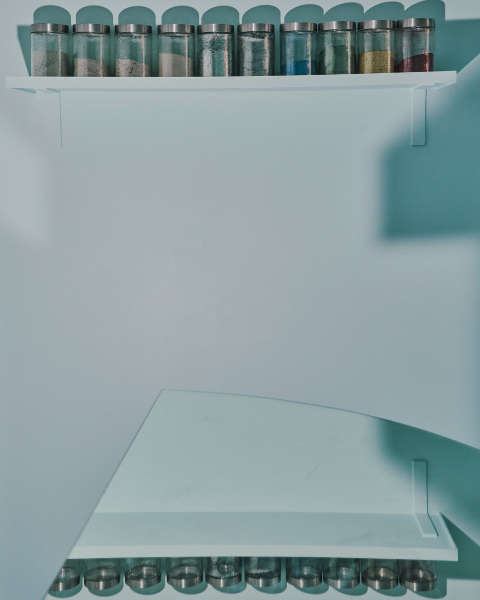Shelf with spice jars on a light blue wall