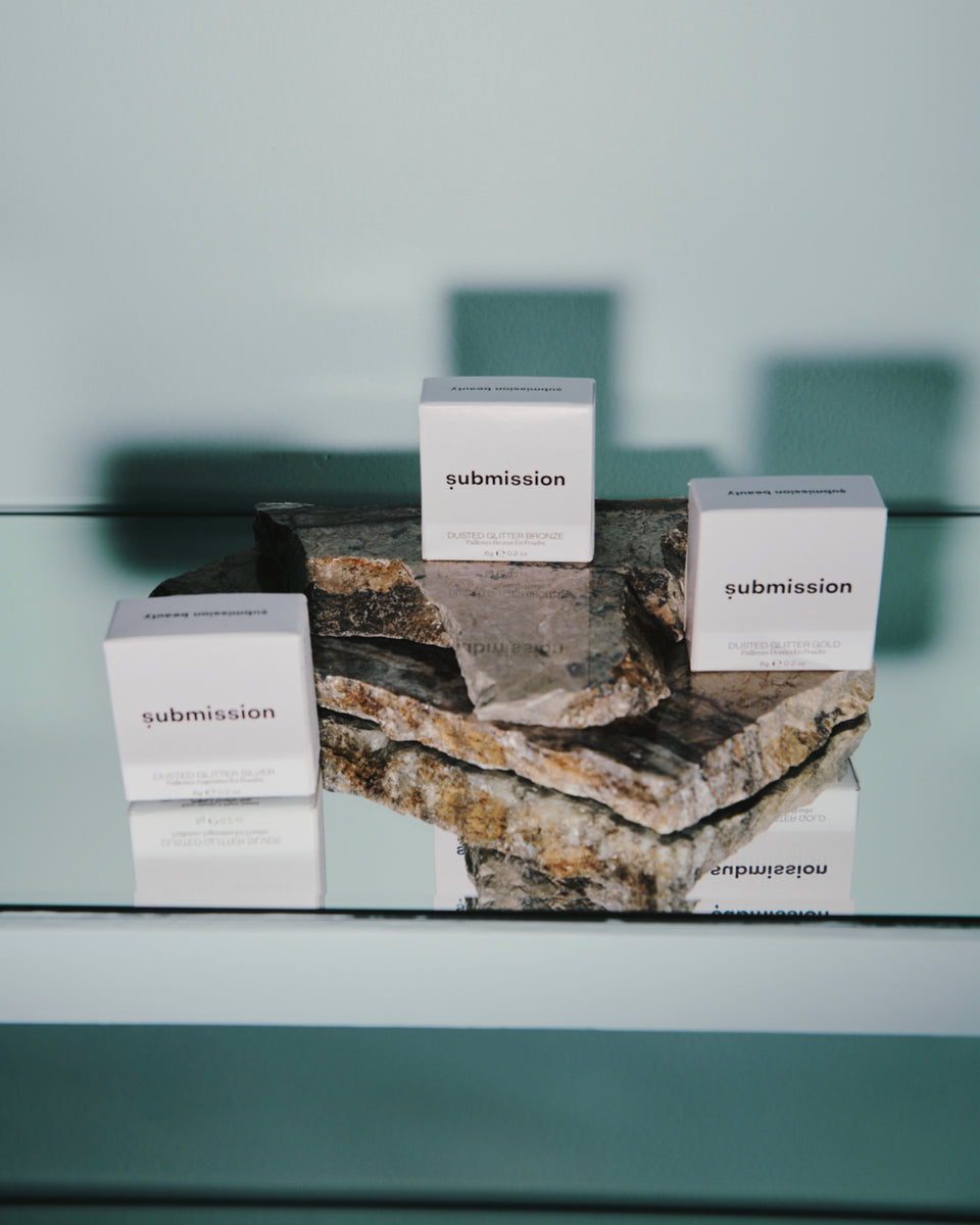 Three 'submission' boxes on a textured surface with a blurred background