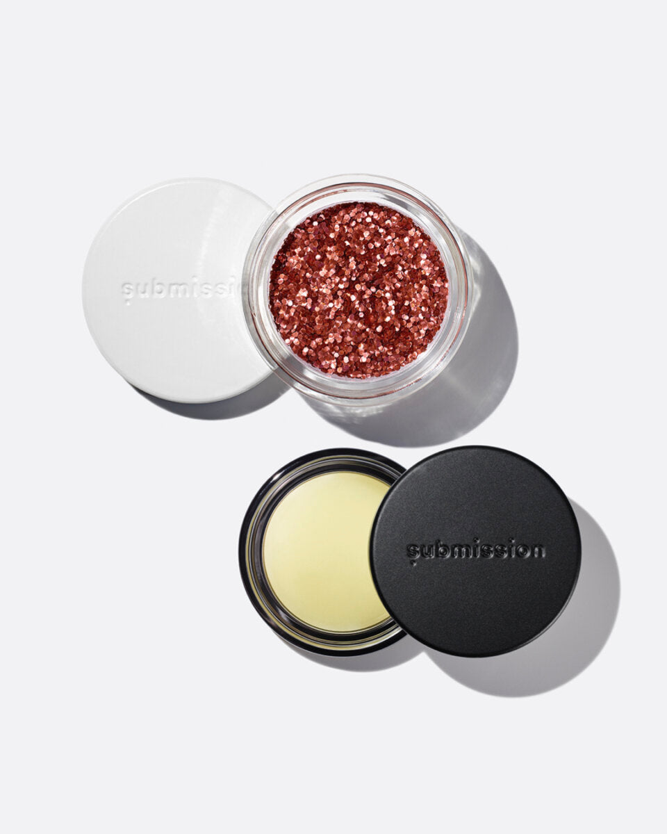 plastic-free plant-based biodegradable red glitter in an open plastic-free container above an open container of Balm Shiny, a multifunctional plant-based balm intended for all skin types.