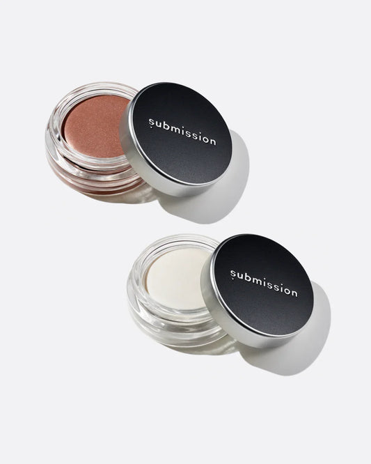 Two open jars of submsision beauty plantbased cream highlighter with 'submission' branding on a white background