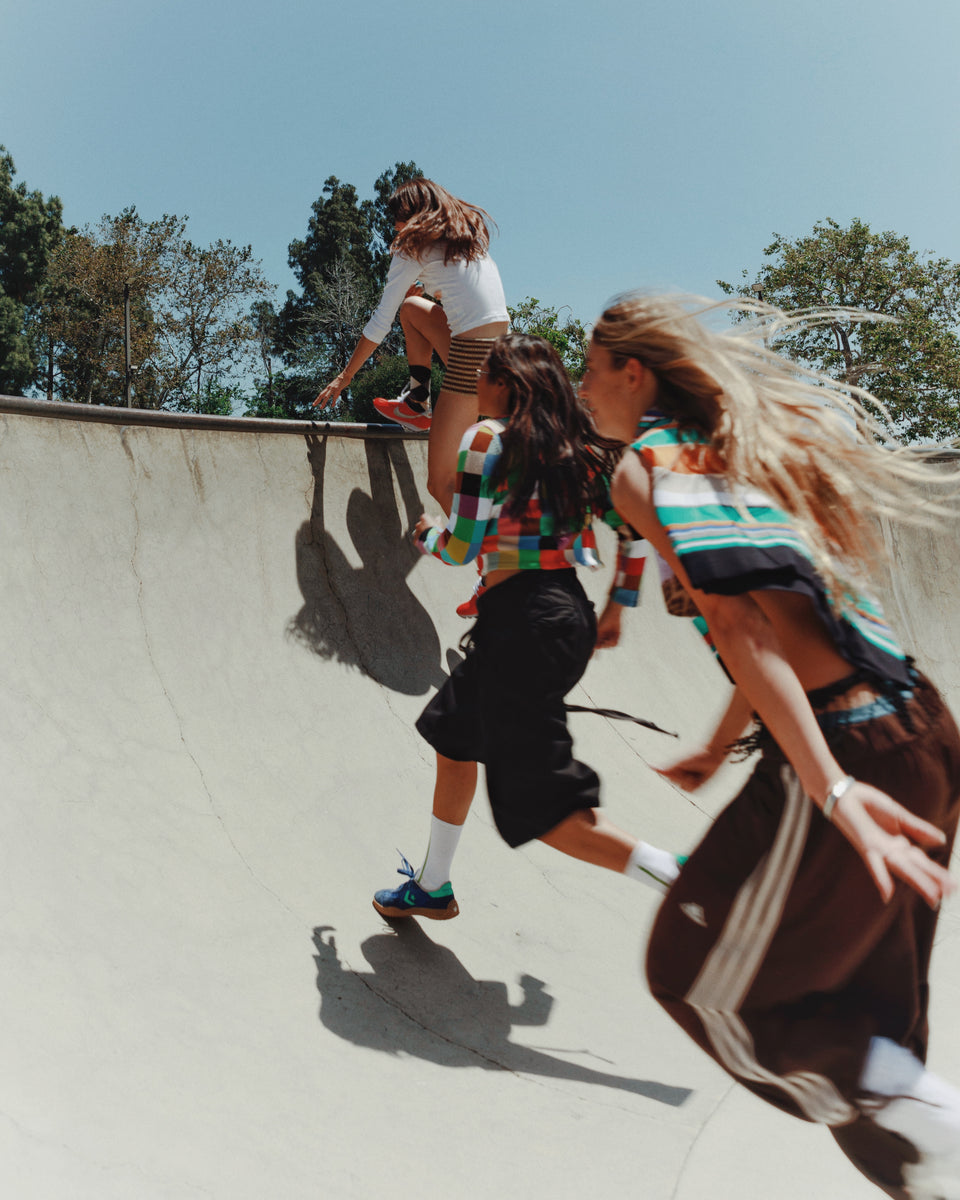 Children playing on a concrete surface with trees in the background