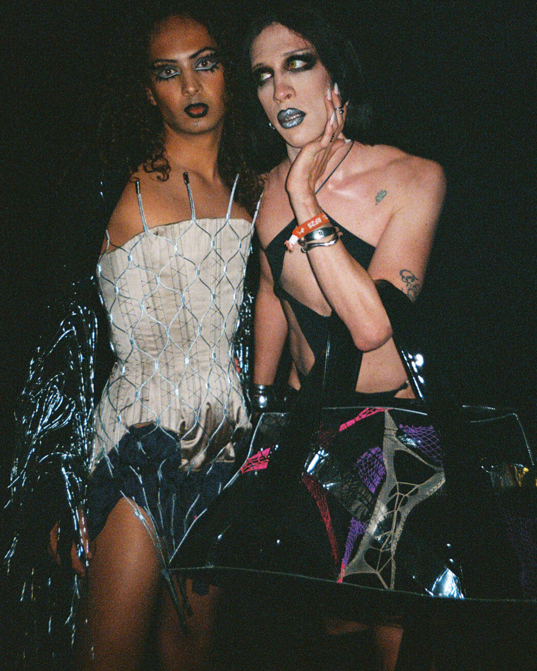 Two women posing together with a dark background backstage at djg2g roskilde festival performance