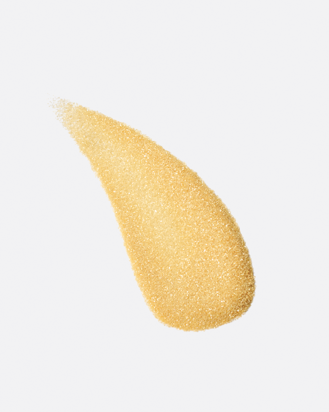 a stylized swipe of plastic-free plant-based biodegradable gold glitter highlighting the glitter’s texture and varied shades of gold