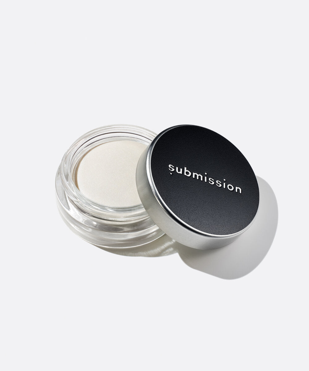 plastic-free plant-based biodegradable  in an open plastic-free container above an open container of Highlighter Light, a multifunctional plant-based highlighter intended for all skin types.