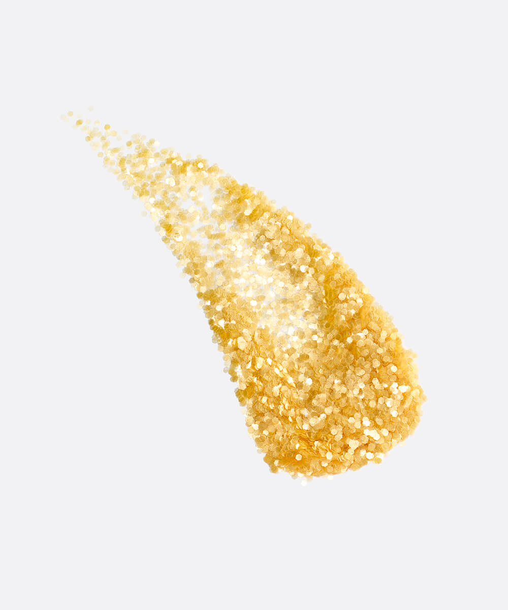 a stylized swipe of plastic-free plant-based biodegradable gold glitter highlighting the glitter’s texture and varied shades of gold