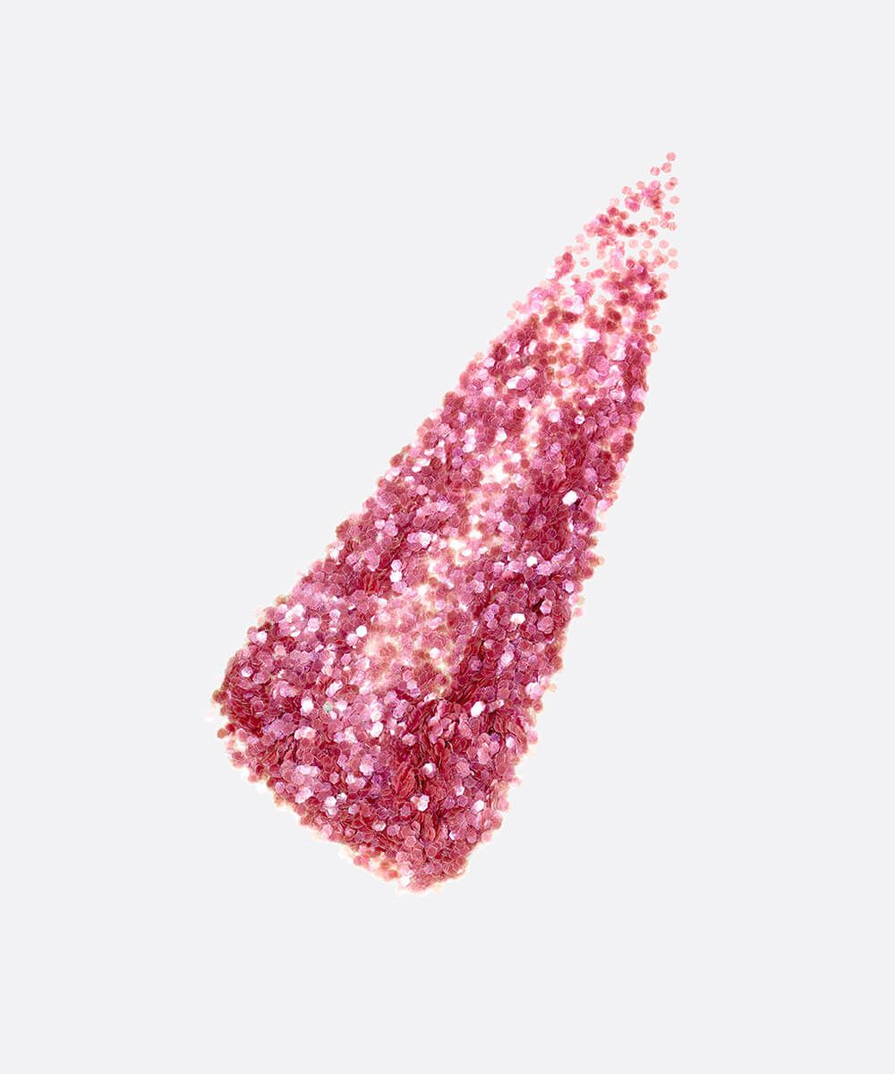 a stylized swipe of plastic-free plant-based biodegradable pink glitter highlighting the glitter’s texture and varied shades of pink